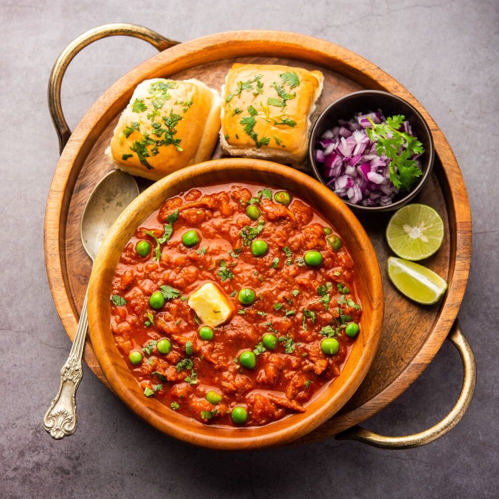 Pav bhaji is a fast food dish from India consisting of a thick vegetable curry served with a soft bread roll